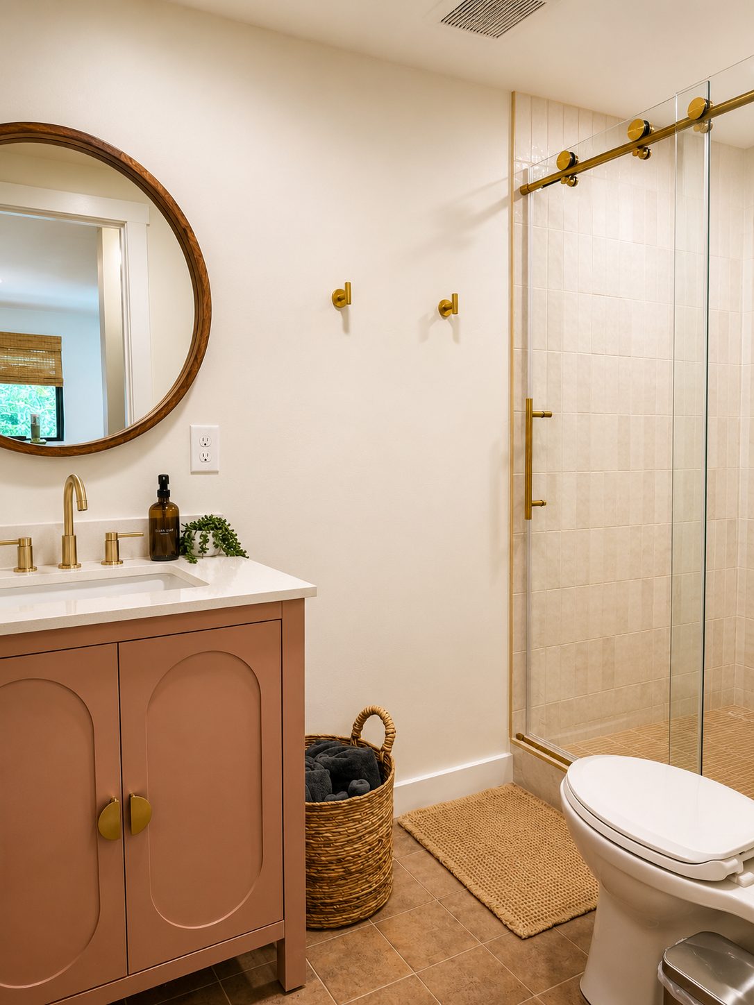 Guest bathroom remodel with terracotta vanity, brass fixtures, and walk-in shower by Far West Construction in Fort Collins, CO